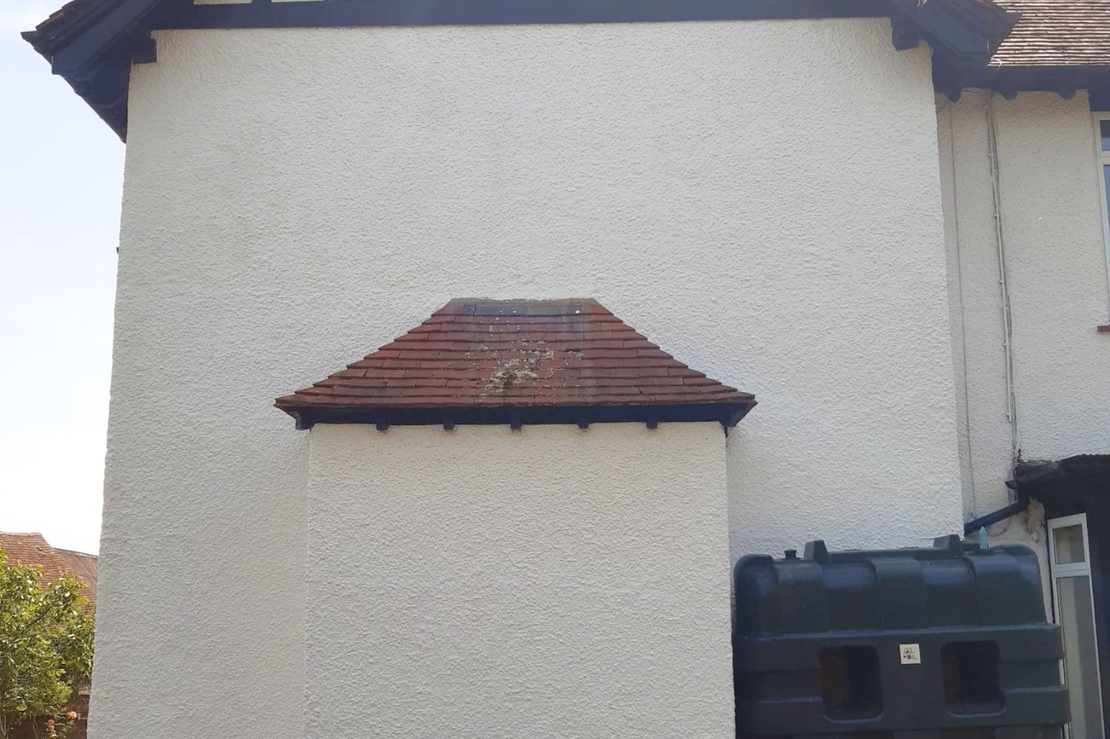 White rendered wall restored after light pressure washing and chemical cleaning in Rayleigh